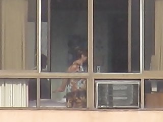 Mature woman naked in the window