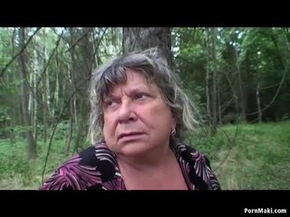 Busty granny having fun in the forest